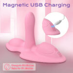 Pink silicone vibrator on a pink surface with a USB charging inset showing charging LEDs and '5V DC' label, promotional text at bottom corner.