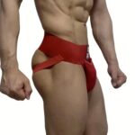 Man wearing a red jockstrap with a wide waistband and front pouch, shown from the side.