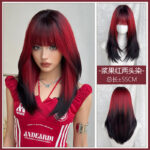 Woman with red and black layered hair, wearing a red top, looking at the camera (collage showcasing a two-tone wig style).