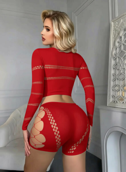 Side profile of a blonde woman wearing a red patterned long-sleeve outfit, posing in a white room with ornate decor.