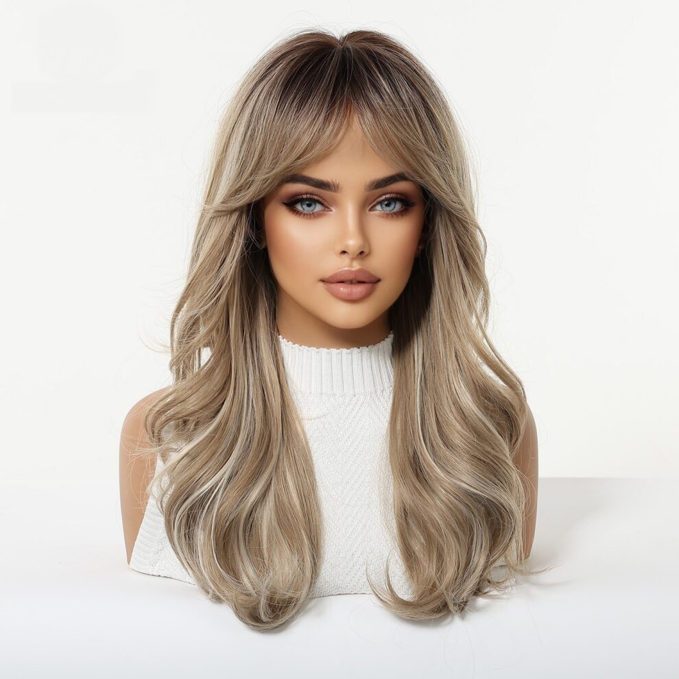 Portrait of a woman with long, wavy ash-blonde hair and blue eyes, wearing a white ribbed turtleneck against a light background.