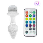 Crystal-shaped LED light with a detachable top next to a multi-color remote control for changing colors and effects.