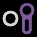 White circular ring and a purple loop-shaped silicone object on a black background