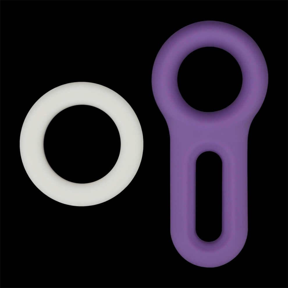 White circular ring and a purple loop-shaped silicone object on a black background
