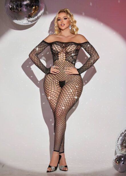 Woman posing in a black fishnet bodysuit with off-the-shoulder neckline and high heels in a disco-themed studio scene.