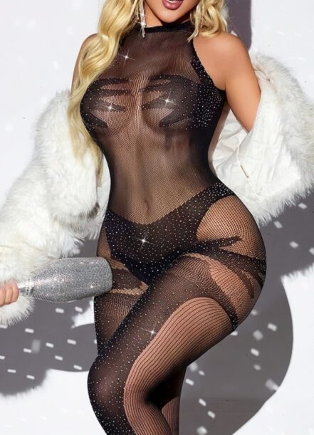 Model in a sheer black rhinestone mesh bodysuit with a white faux fur coat, holding a sparkly silver clutch.