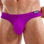 Close-up of a male wearing a purple jockstrap with a branded waistband reading JOCKMAIL.